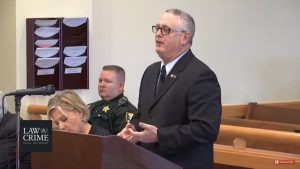 Jay Brizel ’87 in a Florida courtroom in 2019 wearing his Augsburg pin